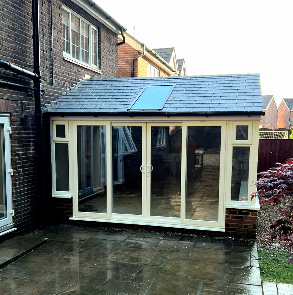 Modern conservatory extension with tiled roof on a residential property