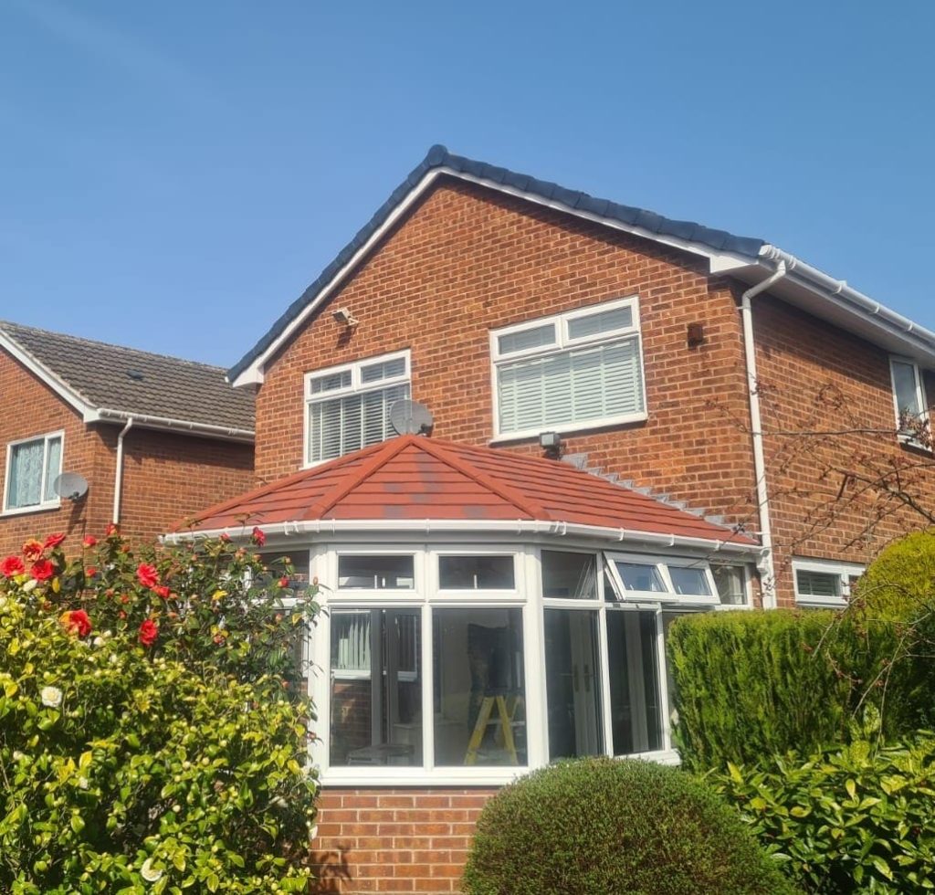 Completed conservatory roof with slate-effect tiles on a period property